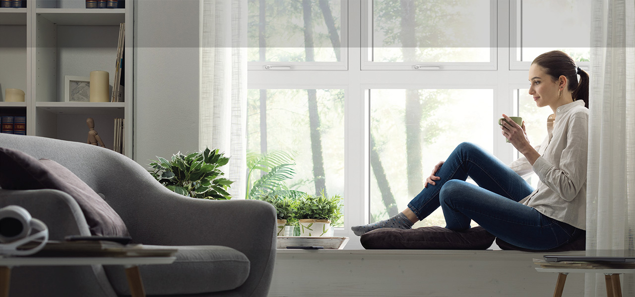 Woman relaxing in front of window